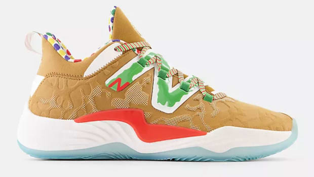 Side view of brown and green New Balance shoe.